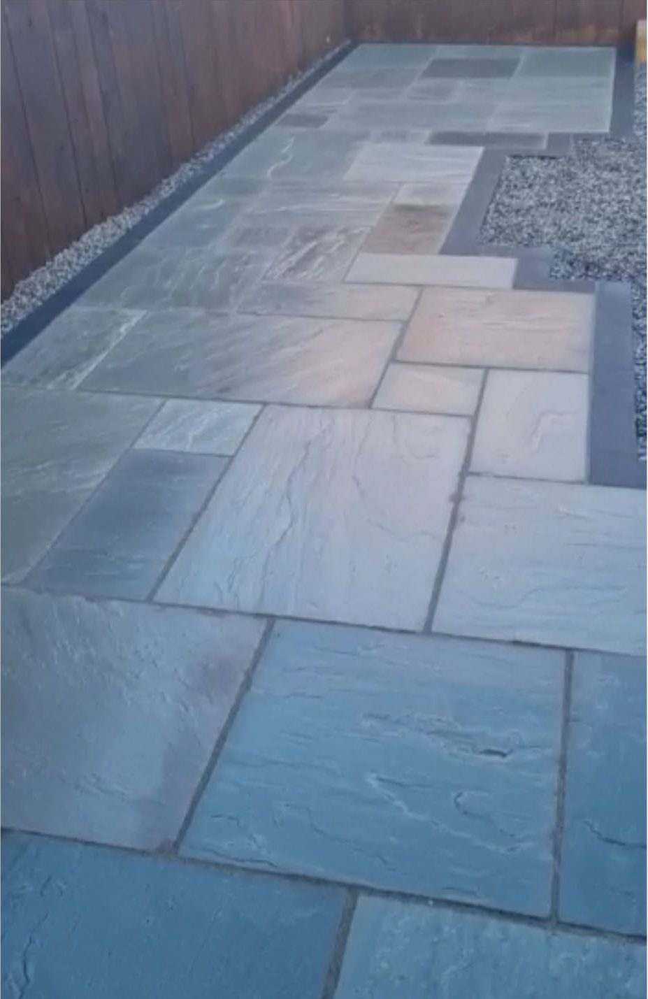 Close view of newly laid grey sandstone patio slabs