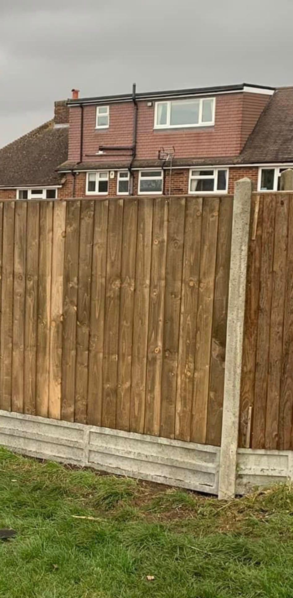 Close-board timber fencing with concrete posts and gravel boards