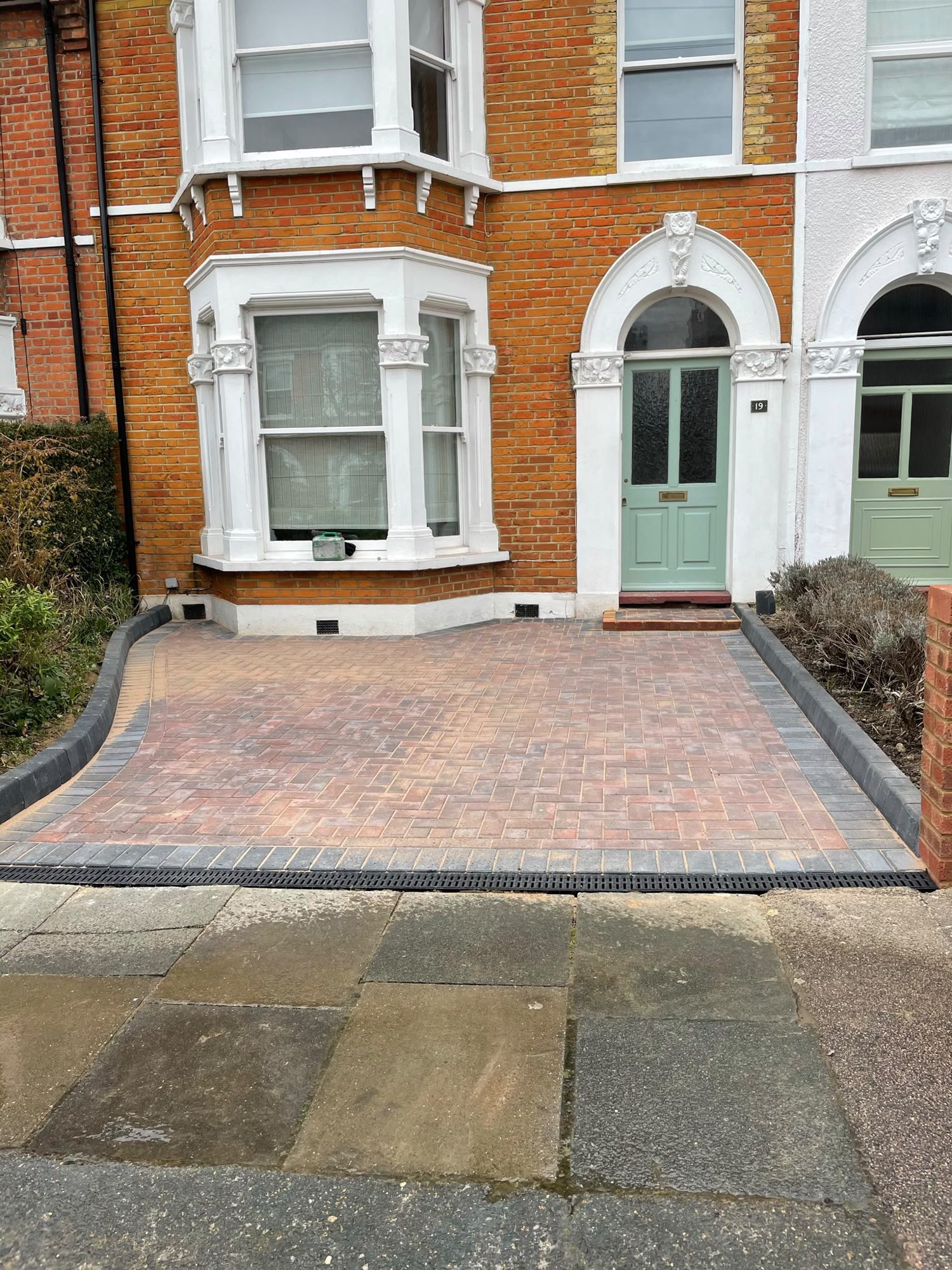 Red block paving driveway with charcoal border outside a Victorian terrace house