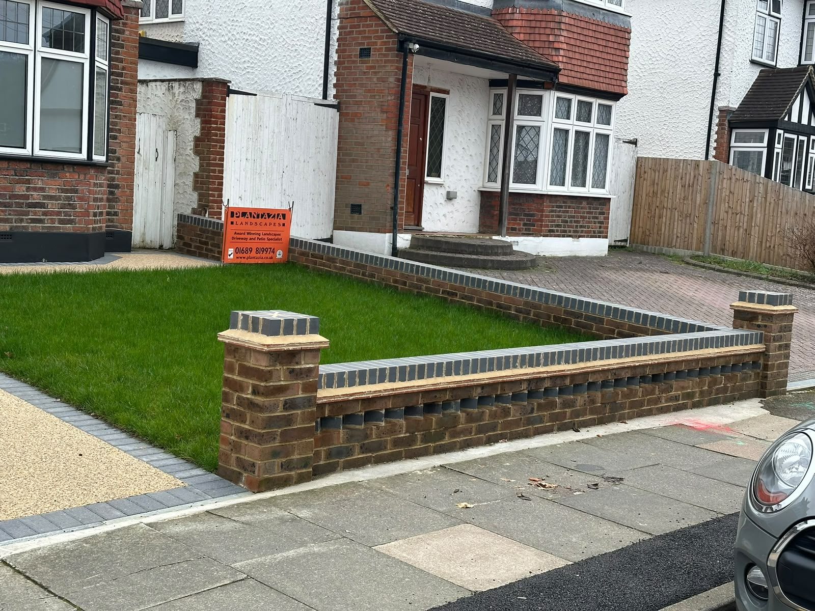 New low brick front garden wall with piers and coping stones