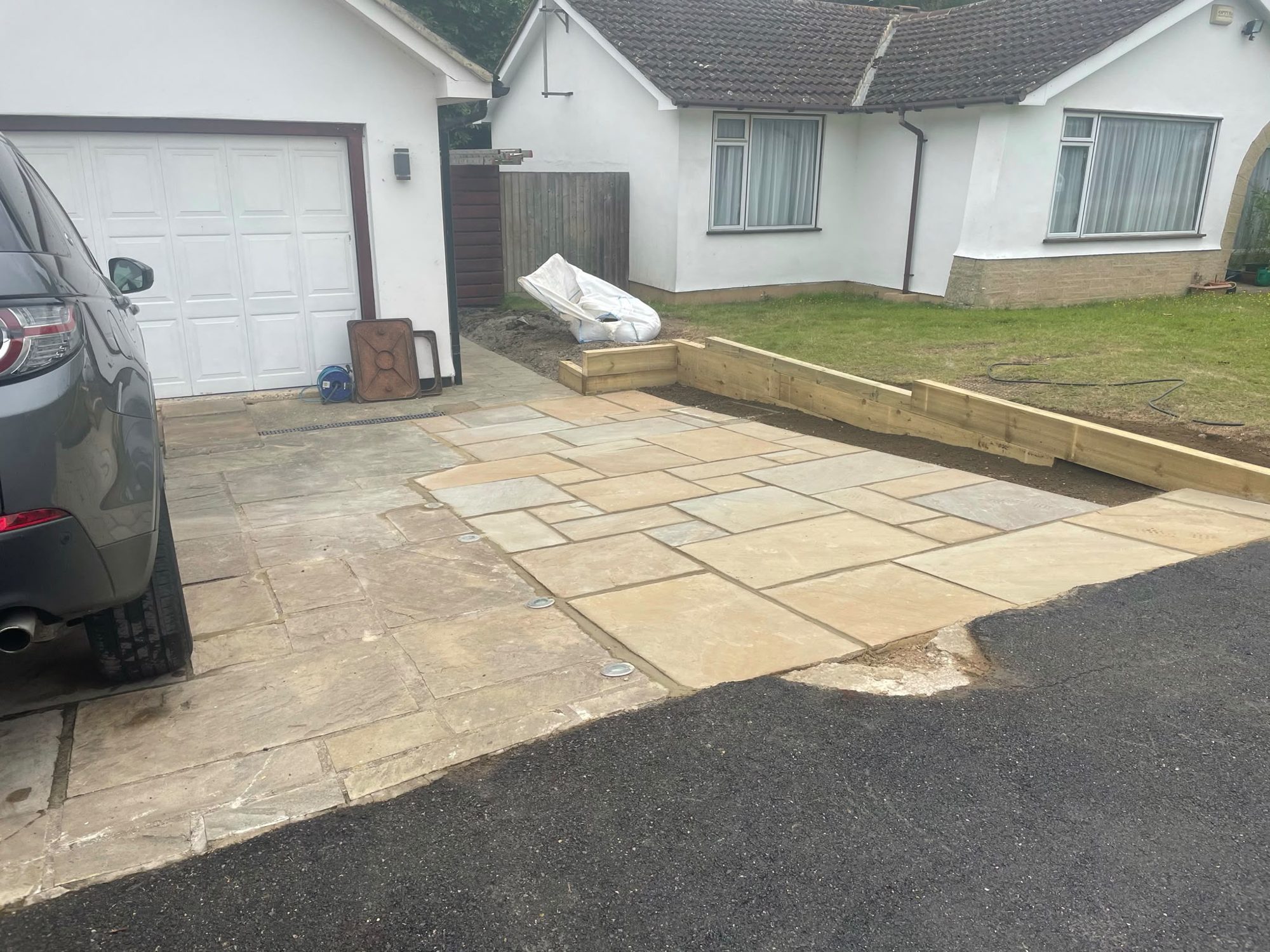 Sandstone paving laid at the front of a bungalow driveway